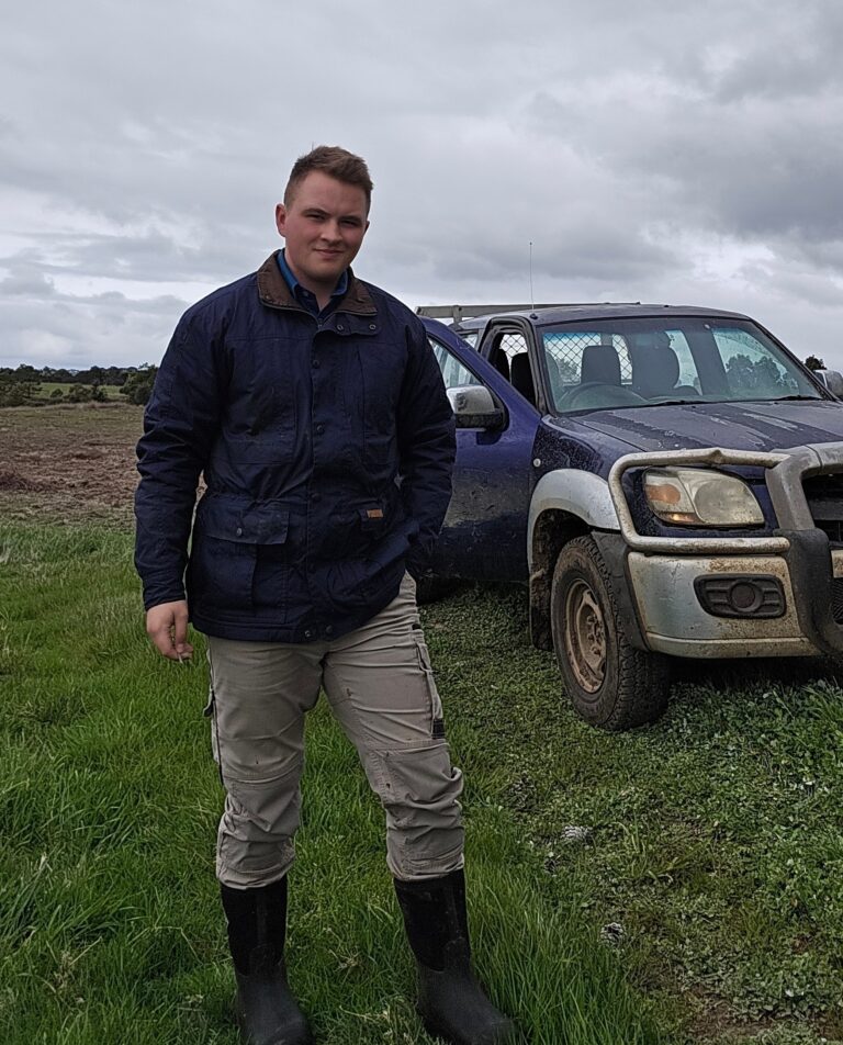 A Daylesford Foundation scholarship recipient standing in a paddock beside a farm ute